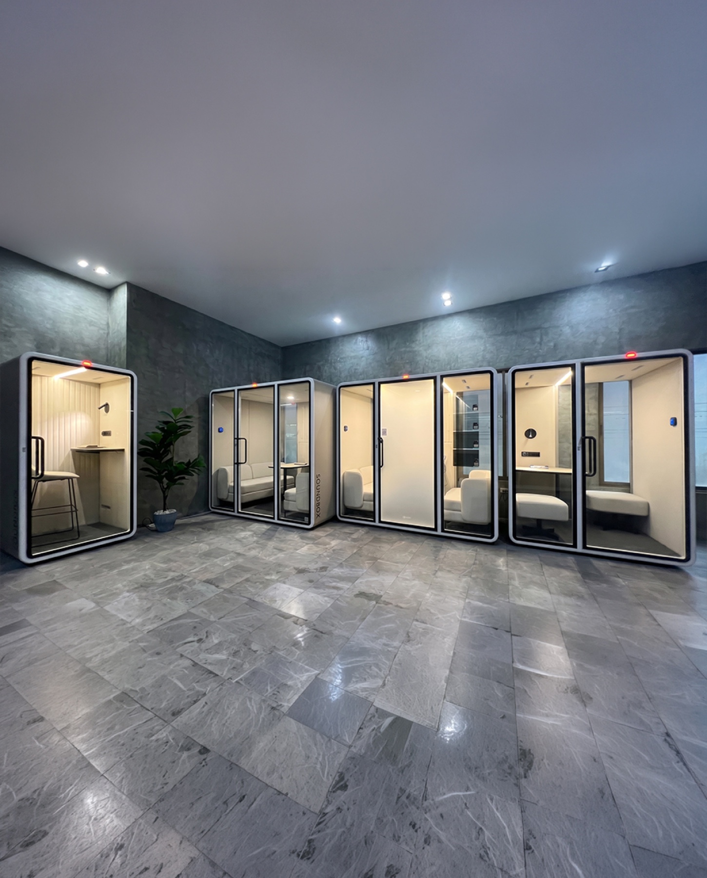 ZOUND pods lined up in a luxury stone-floored showroom